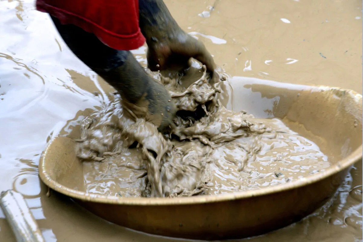 A woman sieves through the mud to find gold dust at a gold mine in Central African Republic in a file photo. (Issouf Sanogo/AFP via Getty Images)