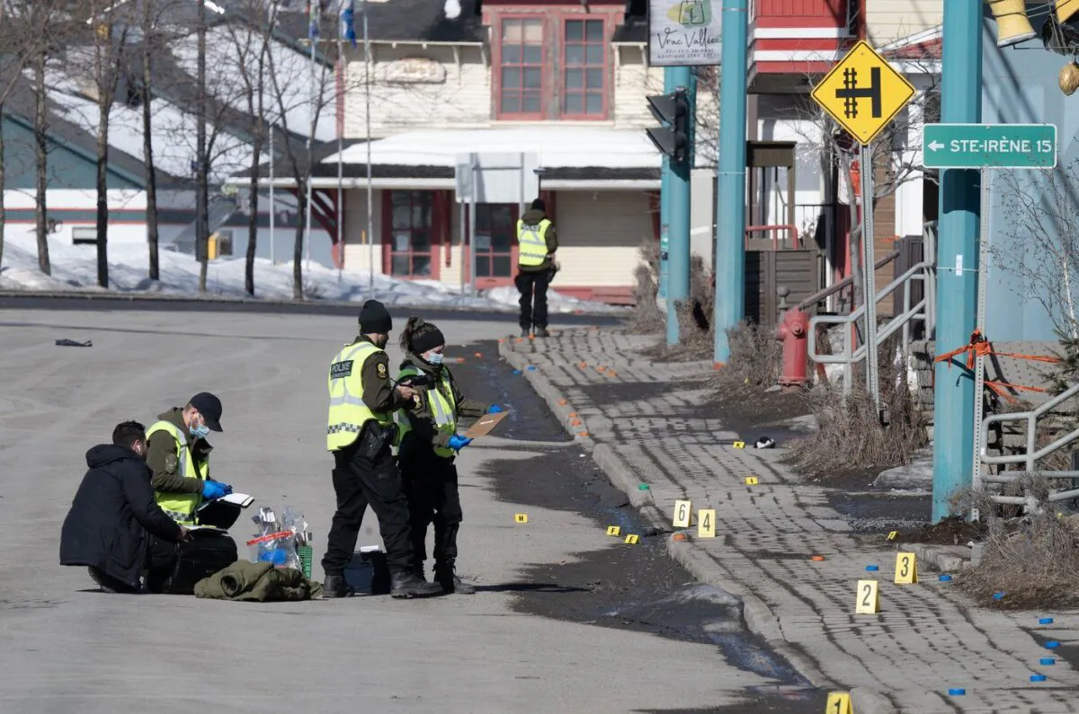 Police officers investigate the scene in Amqui, Que., Mar. 14, 2023. (The Canadian Press/Jacques Boissinot)

