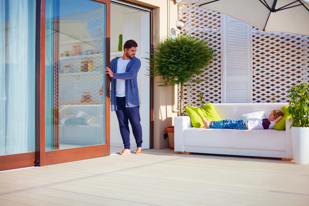 The backyard wood deck is one of the most versatile spaces in the home; it’s the site of birthday parties, family cookouts, al fresco candlelit dinners, and a great place to simply relax. (Olesia Bilkei/Shutterstock)