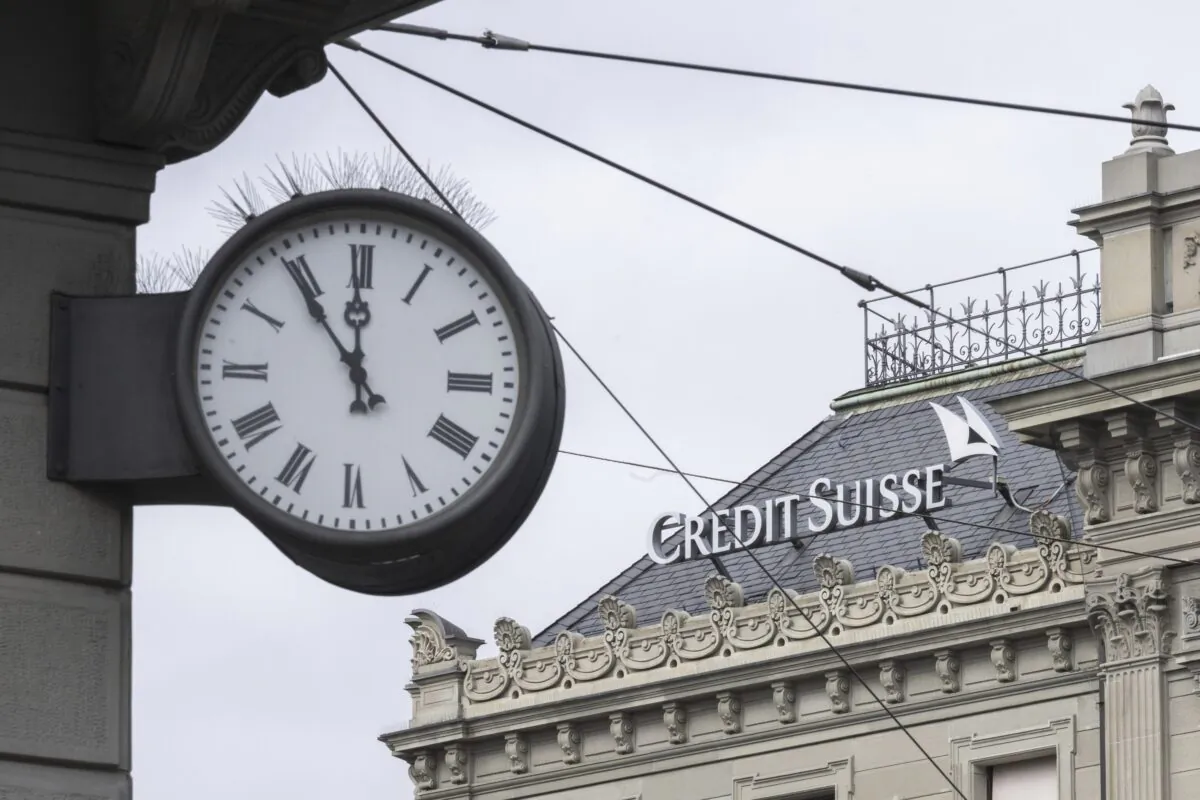 Five to twelve "fuenf vor zwoelf" is written on a clock next to a logo of the Swiss bank Credit Suisse in Zurich on March 20, 2023. (Ennio Leanza/Keystone via AP)