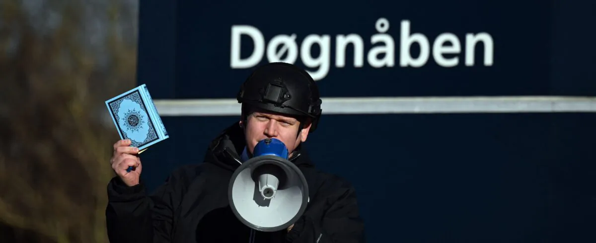 Politician Rasmus Paludan holds up a copy of the Quran as he speaks in front of a mosque in Copenhagen, Denmark, on Jan. 27, 2023. (Sergei Gapon/AFP via Getty Images)