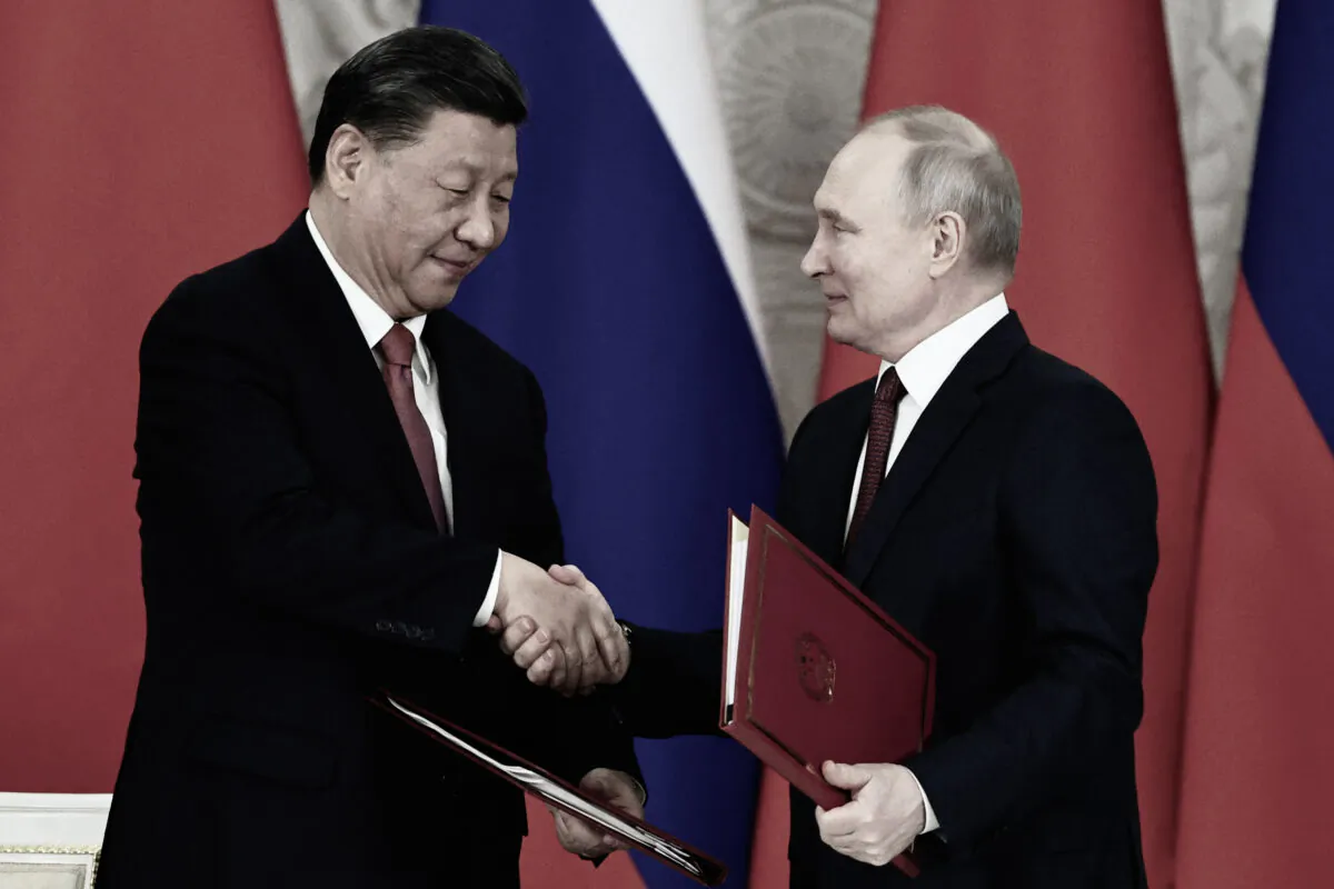 Russian President Vladimir Putin and Chinese leader Xi Jinping shake hands during a signing ceremony following their talks at the Kremlin in Moscow on March 21, 2023. (Mikhail Tereshchenko/Sputnik/AFP via Getty Images)