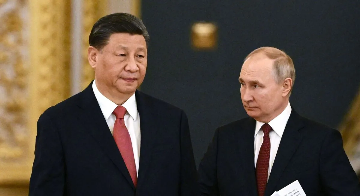 Russian President Vladimir Putin (right) and Chinese leader Xi Jinping enter a hall during a meeting at the Kremlin in Moscow, Russia, on March 21, 2023. (Alexey Maishev/Sputnik/AFP via Getty Images)
