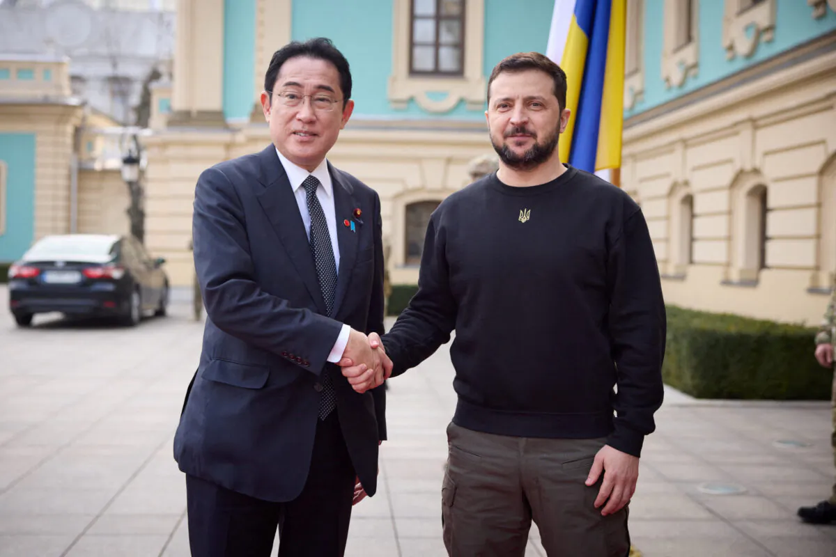 Ukraine's President Volodymyr Zelenskyy and Japan Prime Minister Fumio Kishida (L) shake hands as they meet in Kyiv, Ukraine, on March 21, 2023. (Ukrainian Presidential Press Service/Handout via Reuters)