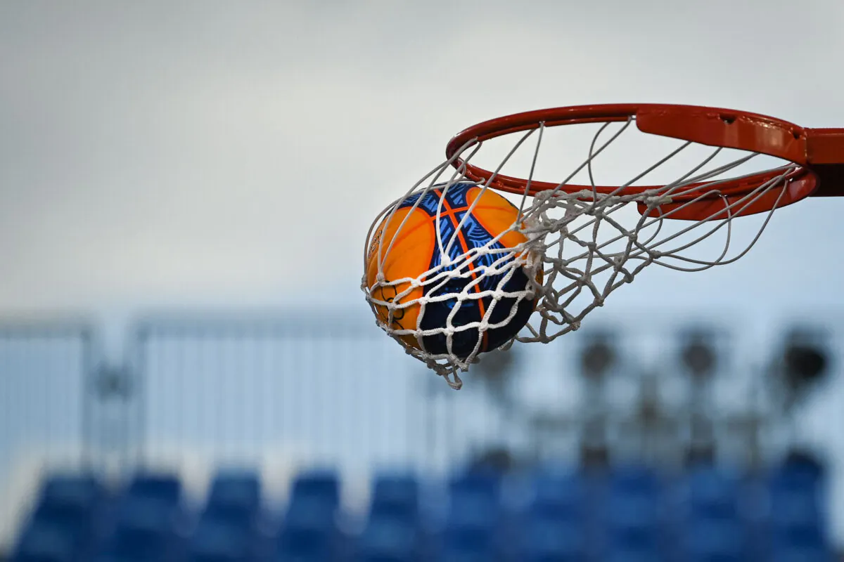 A ball is pictured entering the basket during a women's basketball match on July 27, 2020. (Ina Fassbender/AFP via Getty Images)