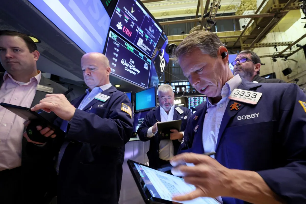 Traders work on the floor of the New York Stock Exchange (NYSE) in New York City, on March 20, 2023. (Brendan McDermid/Reuters)