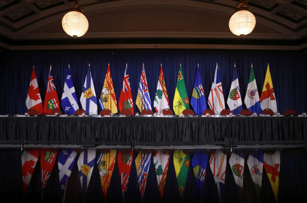The flags of provinces and territories are displayed before a question period with premiers on the final day of a meeting of Canada's premiers in Victoria, B.C., on July 12, 2022. (The Canadian Press/Chad Hipolito)
