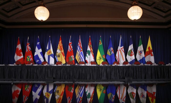 The flags of provinces and territories are displayed before a question period with premiers on the final day of a meeting of Canada's premiers in Victoria, B.C., on July 12, 2022 (The Canadian Press/Chad Hipolito)
