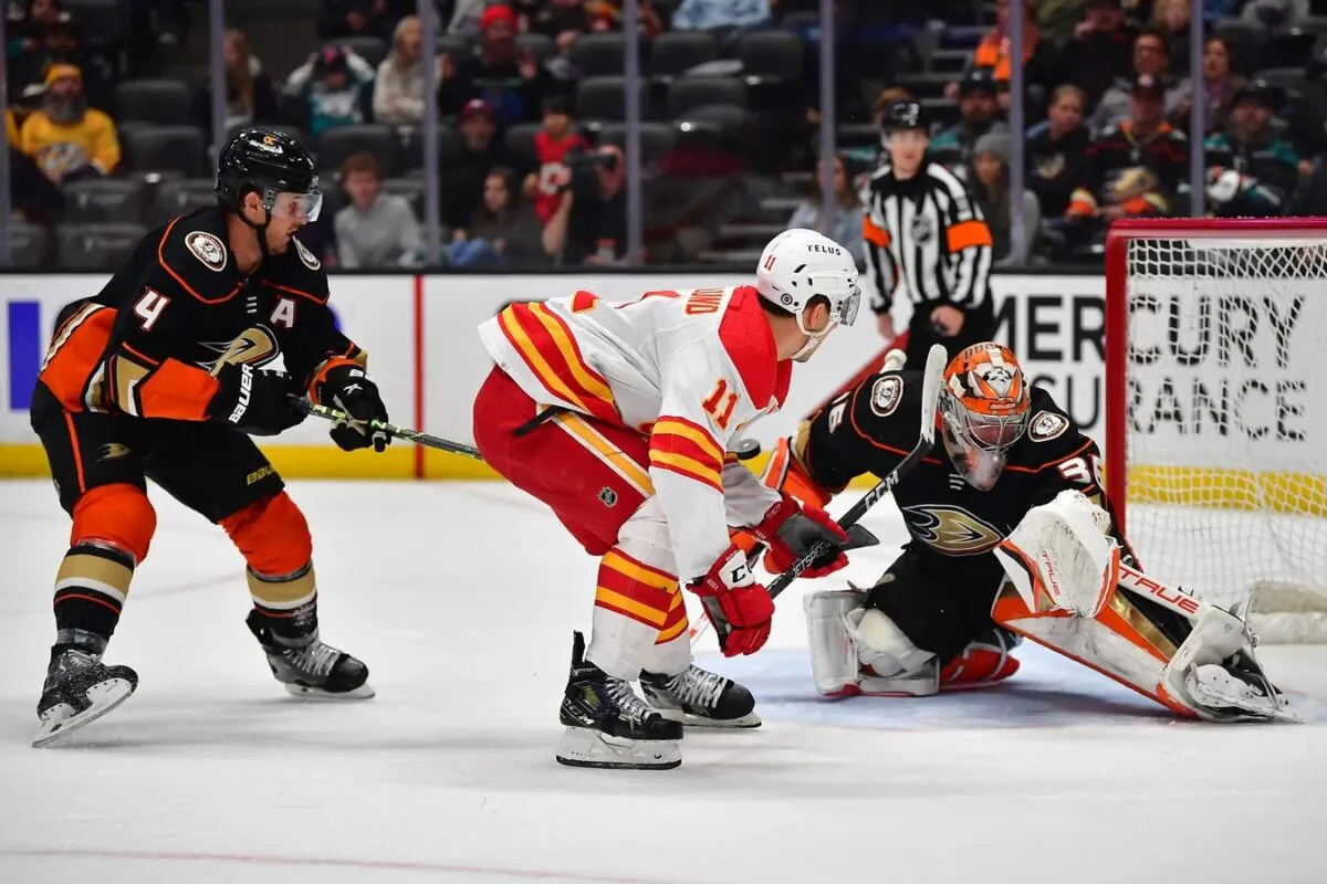 Anaheim Ducks goaltender John Gibson (36) blocks the shot of Calgary Flames center Mikael Backlund (11) as defenseman Cam Fowler (4) helps defend during the first period at Honda Center in Anaheim, Calif., on March 21, 2023. (Gary A. Vasquez-USA TODAY Sports via Field Level Media)
