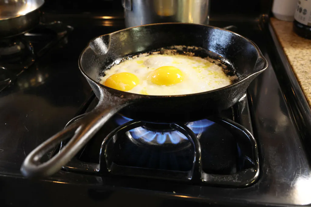 Eggs being cooked in a cast iron pan over flames on a natural gas-burning stove in Chicago, Illinois, on Jan. 12, 2023. (Scott Olson/Getty Images)