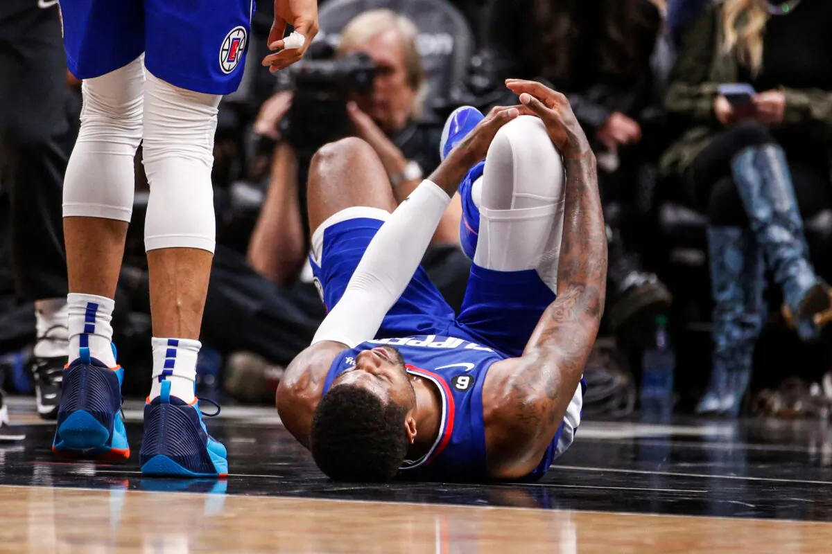 Los Angeles Clippers forward Paul George (R), lies on the court after an injury during the second half of the team's NBA basketball game against the Oklahoma City Thunder in Los Angeles on March 21, 2023. (Ringo H.W. Chiu/AP Photo)