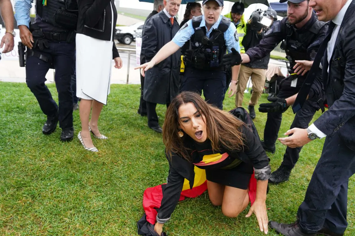 Independent Senator Lidia Thorpe (formerly of the Greens) crawls away after attempting to disrupt British women's rights activist Kellie-Jay Keen-Minshull, also known as Posie Parker, at a “Let Womaen Speak” rally against transgenders entering women's spaces outside Parliament House in Canberra, Australia on March 23, 2023. (AAP Image/Michelle Haywood)