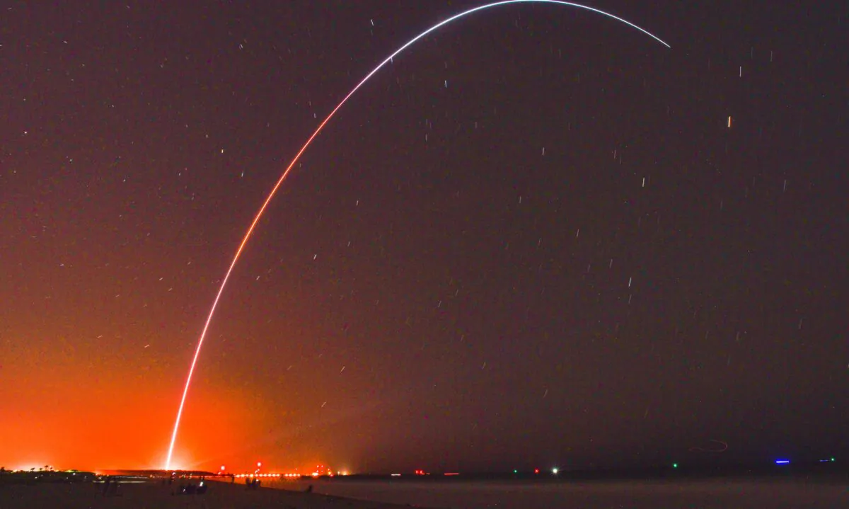 Spectators at Jetty Park in Cape Canaveral, Fla., watch as Terran I, a 3D-printed rocket by Relativity Space, lifts off from Cape Canaveral Space Force Station late on March 22, 2023. (Craig Bailey/Florida Today via AP)