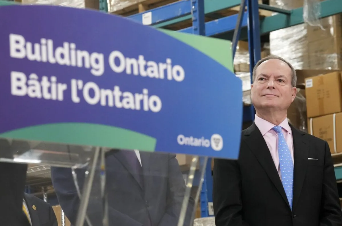 Ontario Finance Minister Peter Bethlenfalvy listens to Ontario Premier Doug Ford speak after touring the Oakville Stamping and Bending Limited facility in Oakville, Ont., on March 22, 2023. (The Canadian Press/Nathan Denette)