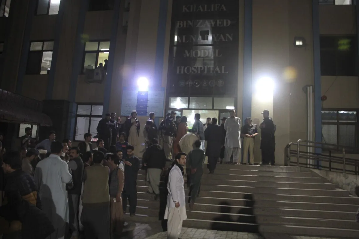 Police officers and people gather at a hospital where earthquake victims are brought in Saidu Sharif, a town Pakistan's Swat valley, on March 21, 2023. (Naveed Ali/AP Photo)