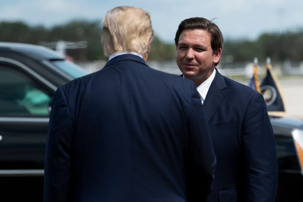 President Donald Trump is greeted by Florida Gov. Ron DeSantis at Southwest Florida International Airport on Oct. 16, 2020. (Brendan Smialowski/AFP via Getty Images)