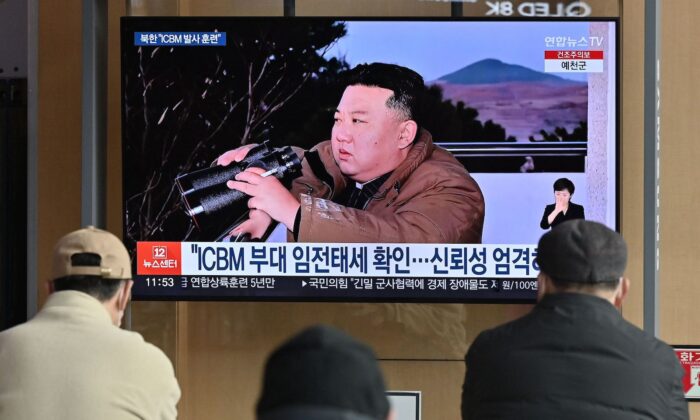 People watch a television news screen showing a picture of North Korea's leader Kim Jong-un witnessing the recent test-firing of a Hwasong-17 intercontinental ballistic missile (ICBM), at a railway station in Seoul on March 17, 2023. (Jung Yeon-je/AFP via Getty Images)