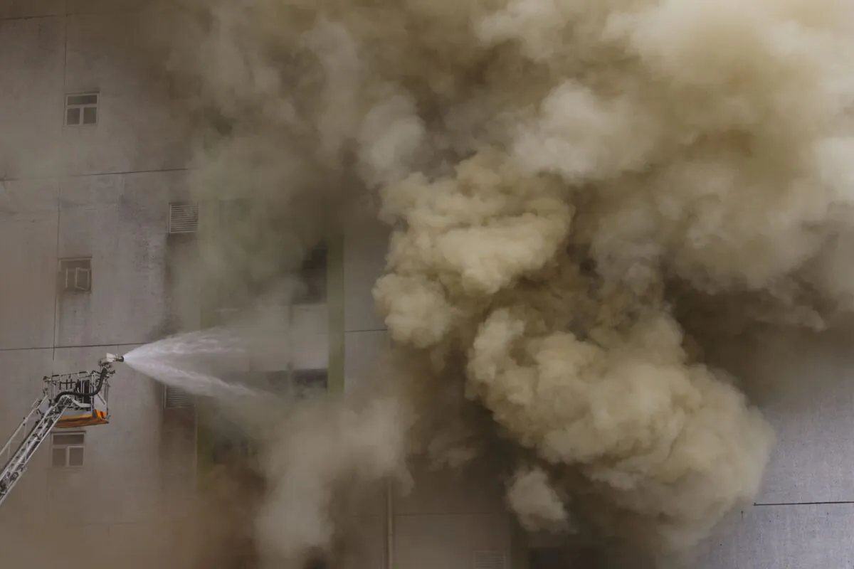 A blaze at a warehouse in the city's bustling Kowloon district in Hong Kong on March 24, 2023. (Tyrone Siu/Reuters)
