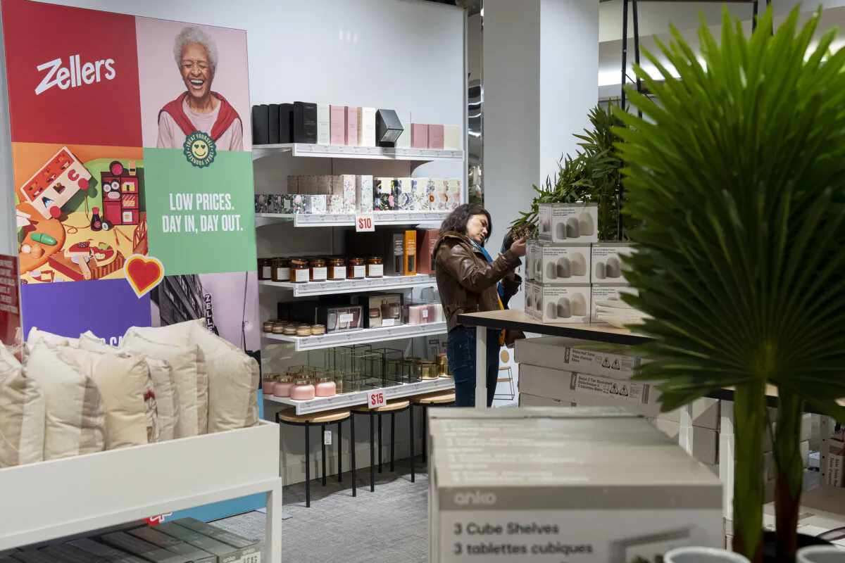 A shopper picks up an item at a newly-opened Zellers store in Scarborough Town Centre Mall, in Scarborough, Ont., on March 23, 2023. (Chris Young/The Canadian Press)