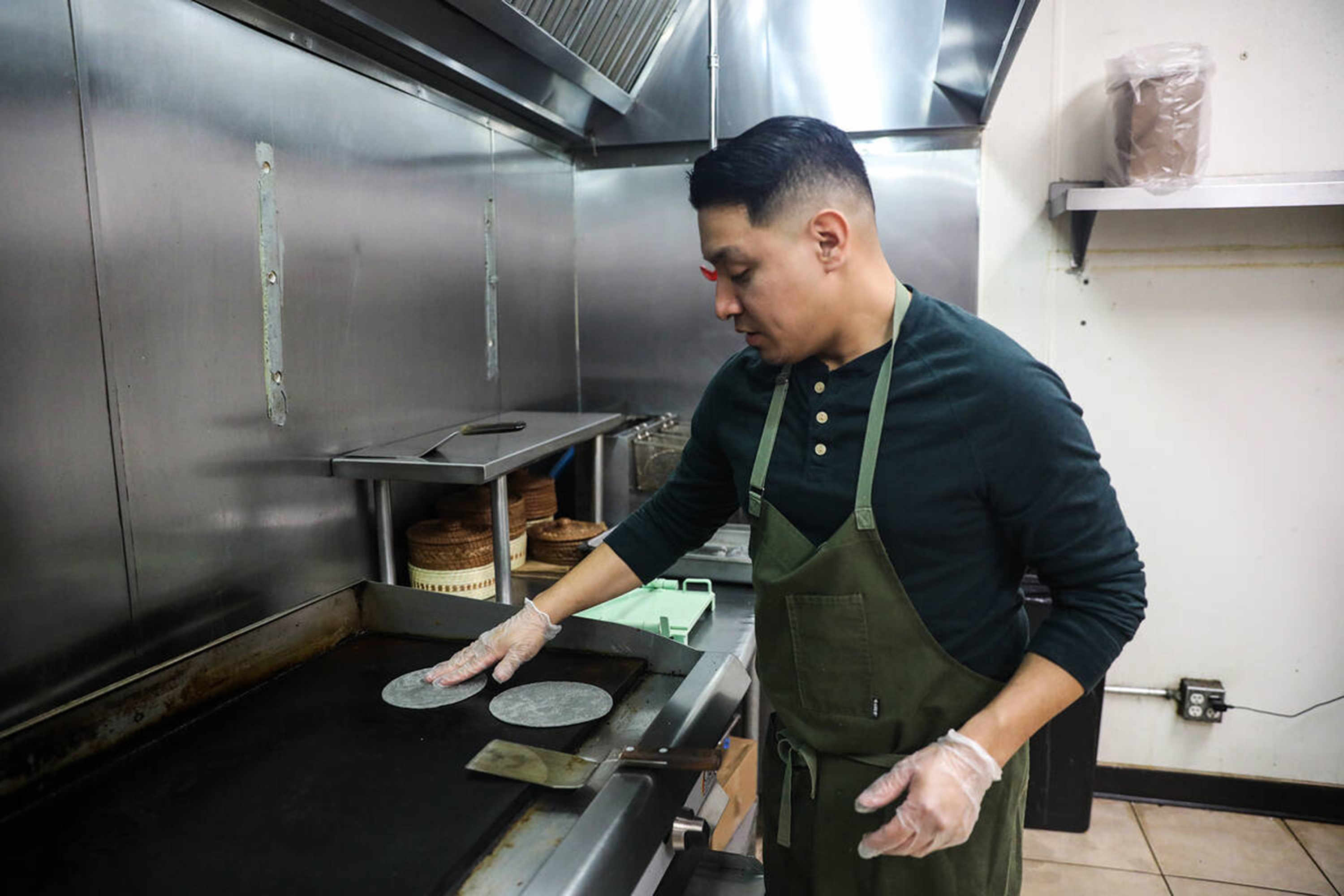 Chef DJ Flores uses freshly made masa to create corn tortillas at Milpa