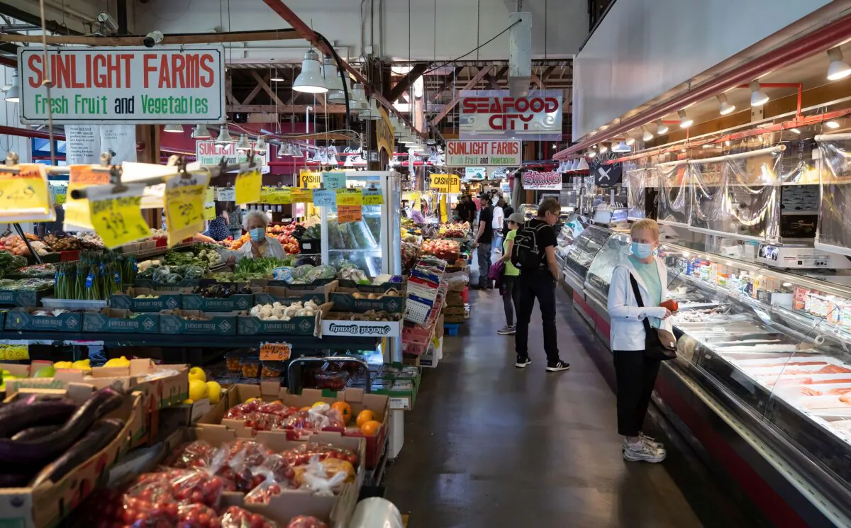 People shop at the Granville Island Market in Vancouver on July 20, 2022. (The Canadian Press/Darryl Dyck)
