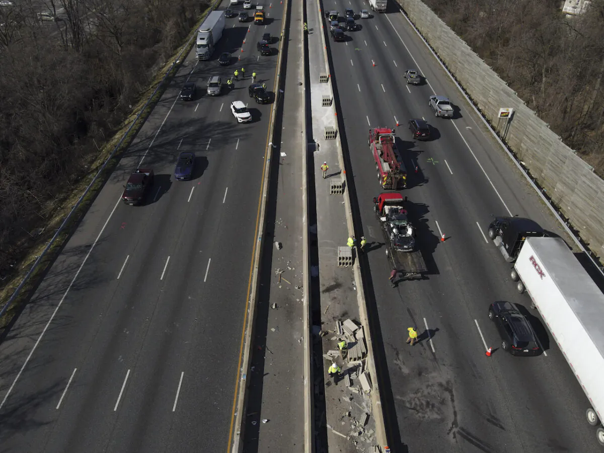 Emergency personnel work at the scene of a fatal crash along Interstate 695 on Wednesday, March 22, 2023, near Woodlawn, Md. Multiple people were killed when a passenger vehicle drove into a work zone along the Baltimore beltway and struck construction workers. (AP Photo/Julio Cortez)