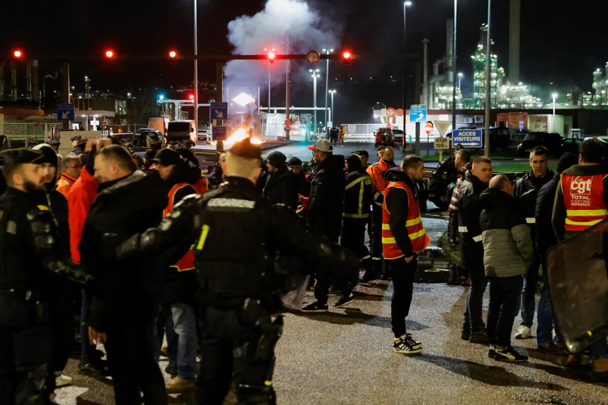 French riot police officers push back energy workers on strike as they gather in front of the TotalEnergies refinery to protest against the French government's pensions reform, in Gonfreville-L’Orcher near Le Havre, France, on March 24, 2023. (Pascal Rossignol/Reuters)