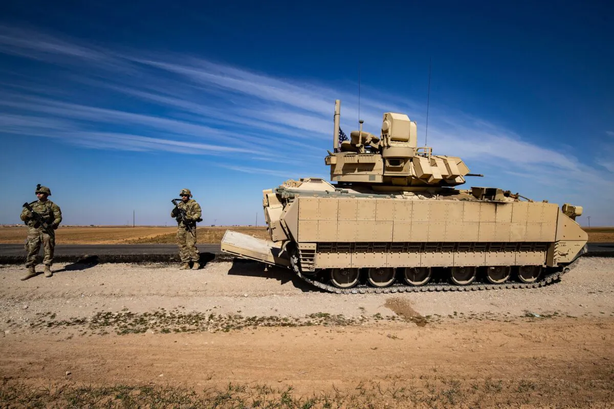 An armoured personnel carrier, part of a U.S. military convoy, patrols in the countryside of Syria's Hasakeh province near the Turkish border on Feb. 18, 2023. (Delil Souleiman/AFP via Getty Images)
