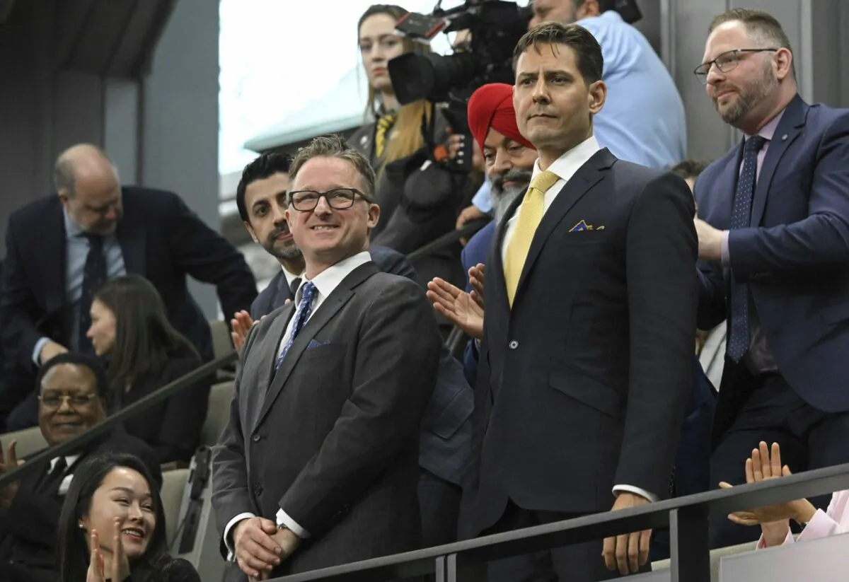 Canadians Michael Kovrig (R) and Michael Spavor receive a standing ovation before U.S. President Joe Biden speaks to the Canadian Parliament, in Ottawa on Mach 24, 2023. (Mandel Ngan/Pool via AP)