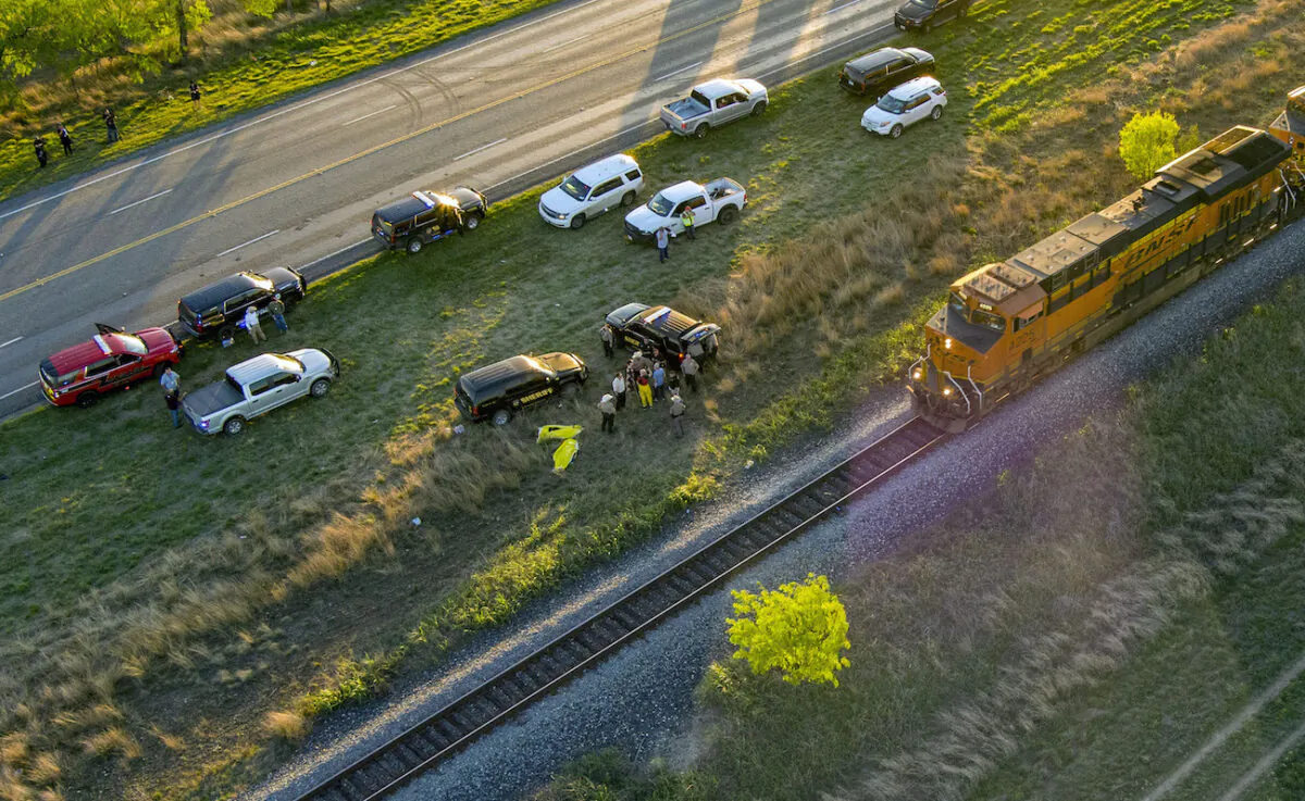 Officials investigate the scene where migrants were found trapped in a train car, in Uvalde, Texas, on March 24, 2023. (William Luther/The San Antonio Express-News via AP)