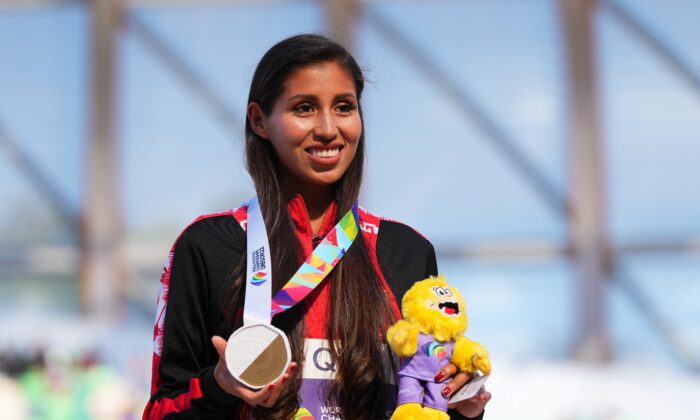 Gold medallist Peru's Kimberly Garcia Leon celebrates on the podium during the medal ceremony after winning the women's 35 kilometers race walk at World Athletics Championships in Eugene, Ore., on July 22, 2022. (Aleksandra Szmigiel/Reuters)