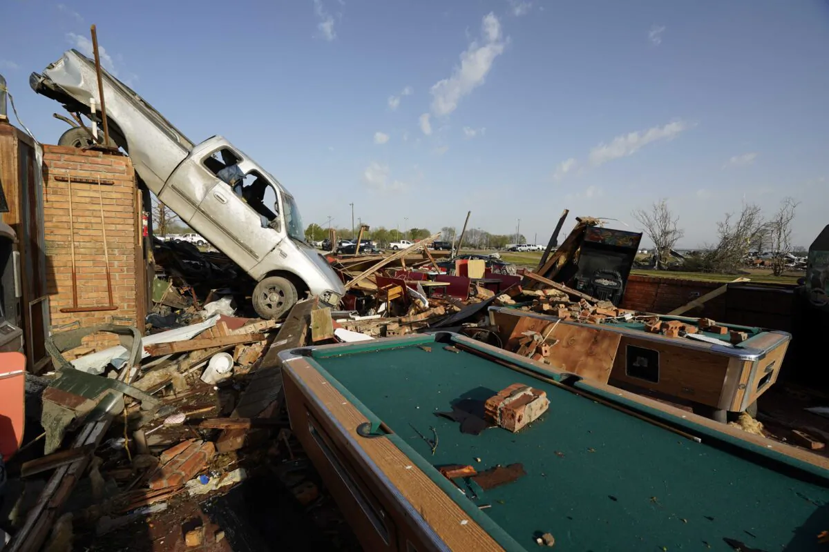 Wind-tossed vehicles, are piled onto another in Rolling Fork, Miss., on March 25, 2023. (Rogelio V. Solis/AP Photo)