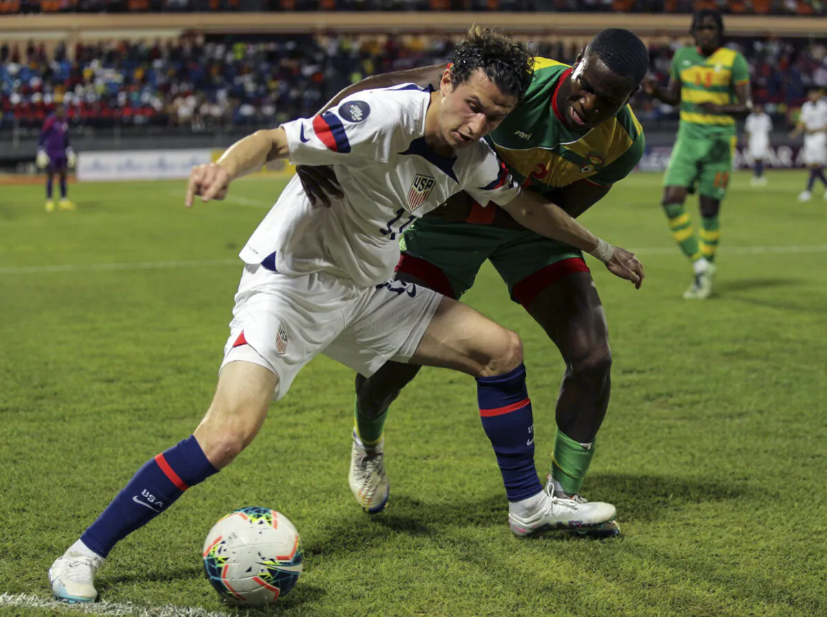 U.S. Brenden Aaronson, left, fights for the ball with Grenada's Benjamin Ettienne, during a CONCACAF Nations League soccer match in Saint George, Grenada, on March 24, 2023. (Haron Forteau/AP Photo)