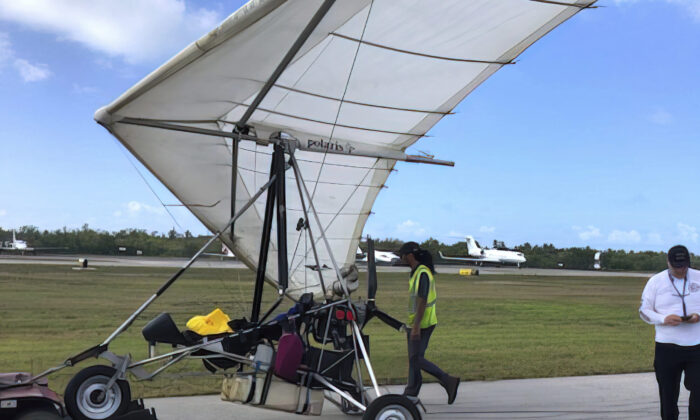 Key West International Airport personnel examine an ultralight aircraft that landed illegally at the airport carrying two Cuban men, in Key West, Fla., on  March 25, 2023. (Monroe County Sheriff's Office /the Florida Keys News Bureau via AP)