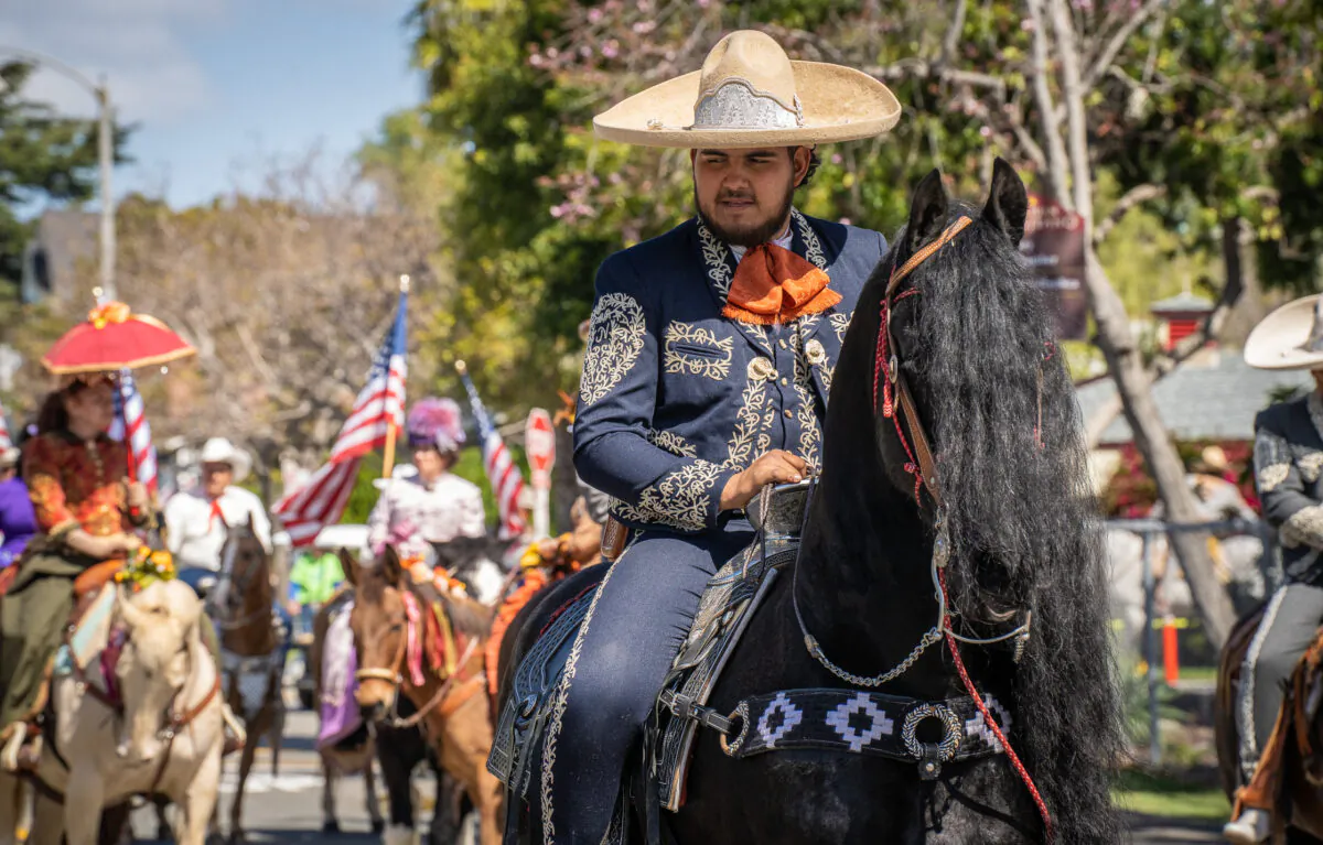 A vaquero walks along with his horse during the Swallows Day Parade in San Juan Capistrano, Calif., on March 25, 2023. (John Fredricks/The Epoch Times)