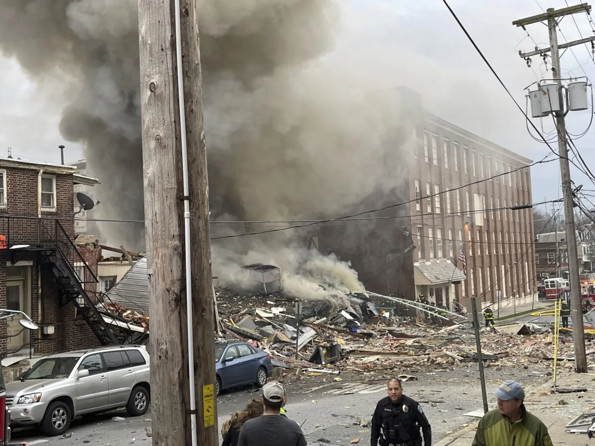 Emergency personnel work at the site of a deadly explosion at a chocolate factory in West Reading, Pa., on March 24, 2023. (Ben Hasty/Reading Eagle via AP)