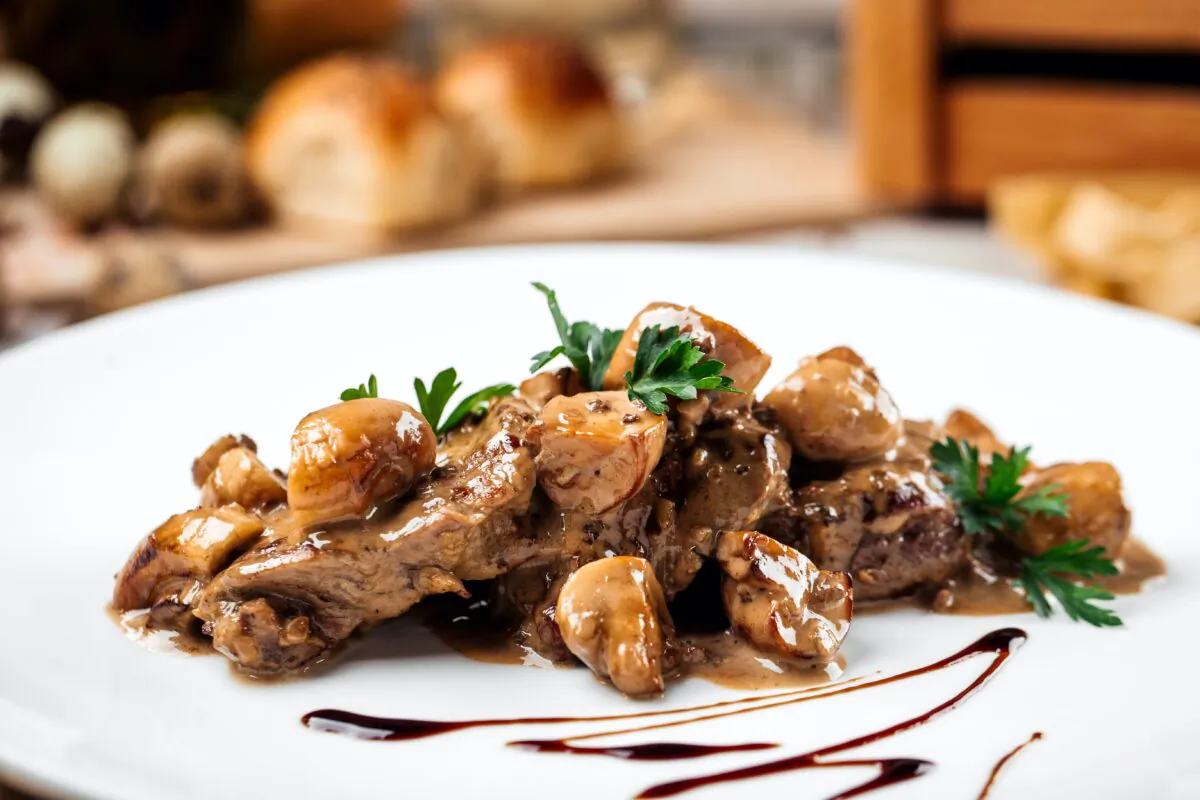 This hunter's steak is served with a sauce of wine, potatoes, onion, mushrooms, and garlic.(Hihitetlin/Shutterstock)