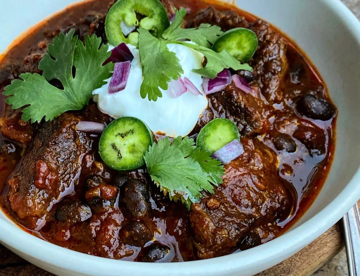 The meat in this chili tenderizes into a heady, smoky ragout, absorbing the flavors and mingling in a swirling brew of beer, tomato, and spice. (Lynda Balslev for Tastefood)