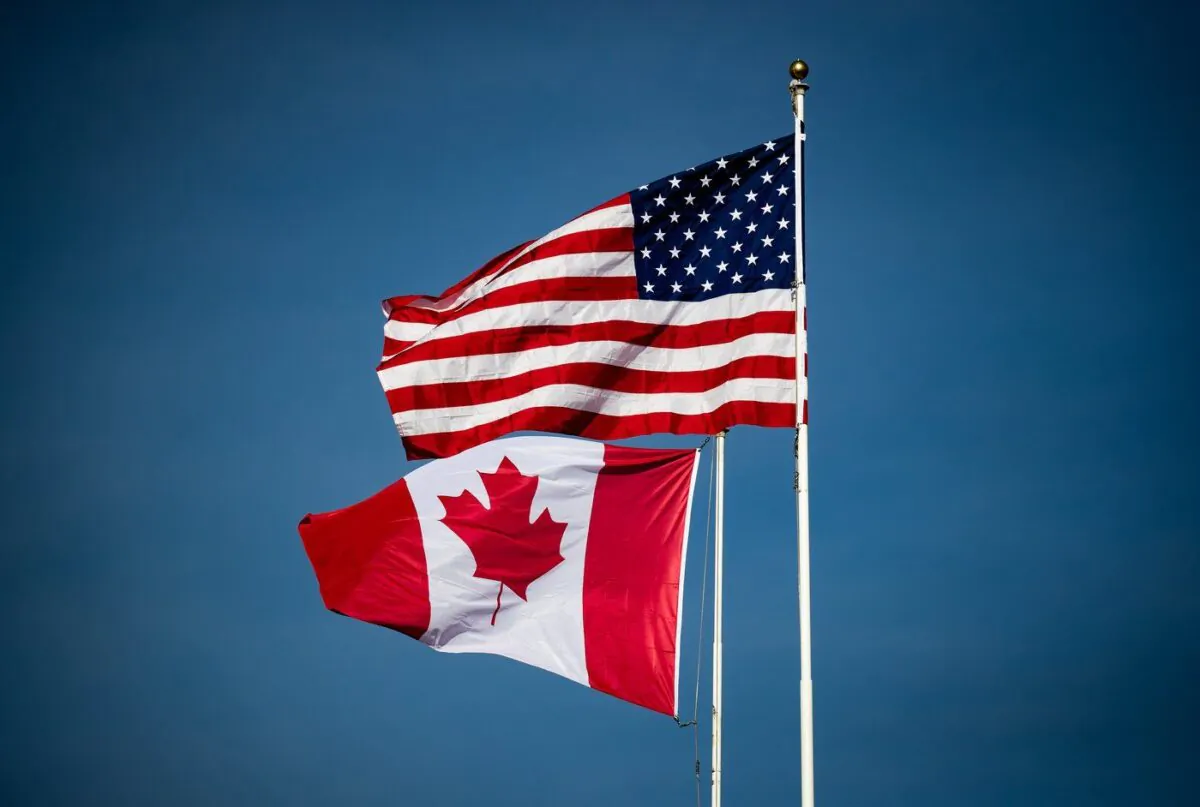 Canadian and U.S. flags fly atop the Peace Arch monument at the Douglas-Peace Arch border crossing in Surrey, B.C., on Nov. 8, 2021. (The Canadian Press/Darryl Dyck)
