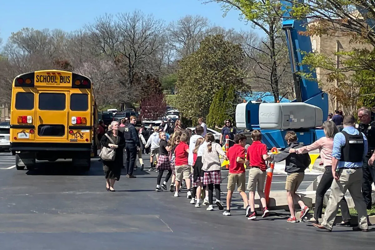 Children from The Covenant School, a private Christian school in Nashville, Tenn., hold hands as they are taken to a reunification site at the Woodmont Baptist Church after a deadly shooting at their school on March 27, 2023. (Jonathan Mattise/AP Photo)