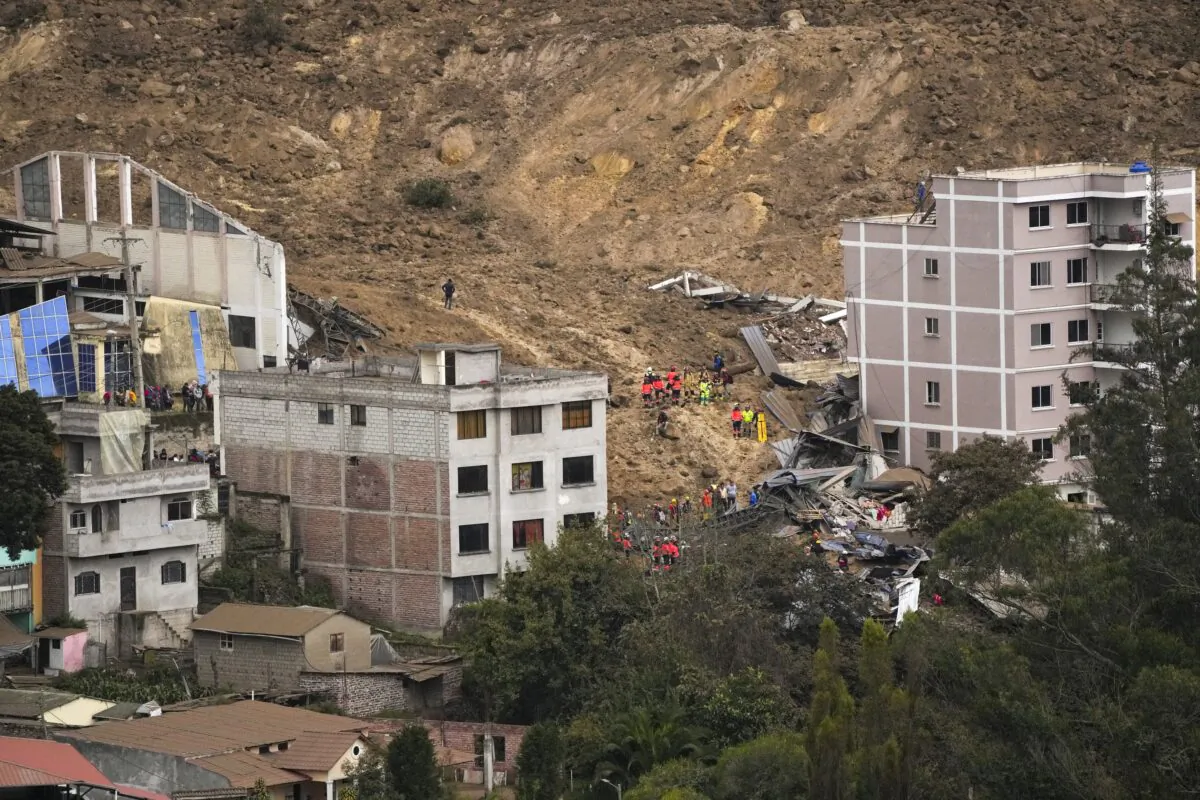 Rescue work is carried out at the site of a landslide caused by heavy rain that buried dozens of homes in Alausi, Ecuador, on March 27, 2023. (Dolores Ochoa/AP Photo)