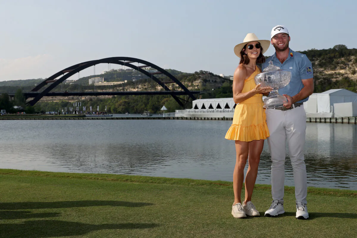Sam Burns of the United States and wife Caroline pose for photos after Burns won the World Golf Championships-Dell Technologies Match Play at Austin Country Club in Austin, Texas, on March 26, 2023. (Harry How/Getty Images)