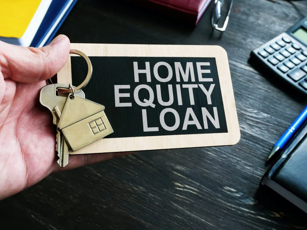 Home Equity Loan sign and key for house. (Vitalii Vodolazskyi/Shutterstock)
