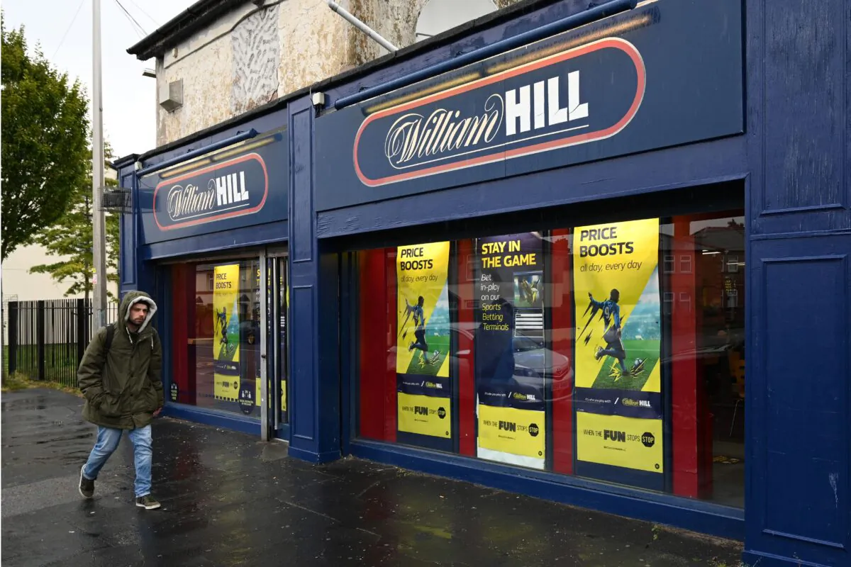A man walks past a William Hill betting shop in Birkenhead, northwest England, on Sept. 30, 2020. (Paul Ellis/AFP via Getty Images)