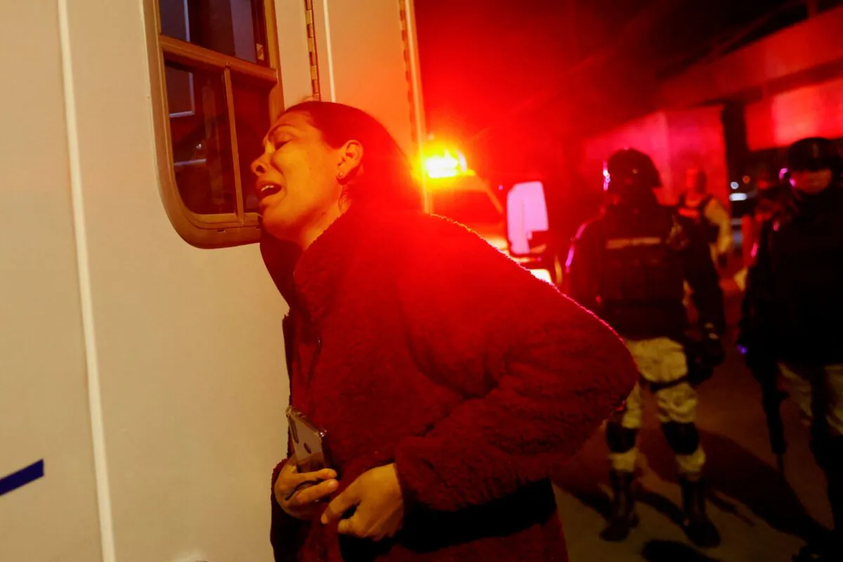 Viangly, a Venezuelan migrant, reacts outside an ambulance for her husband Eduard Caraballo who was injured in the National Migration Institute (INM) building during a fire, in Ciudad Juarez, Mexico, on March 27, 2023. (Jose Luis Gonzalez/Reuters)