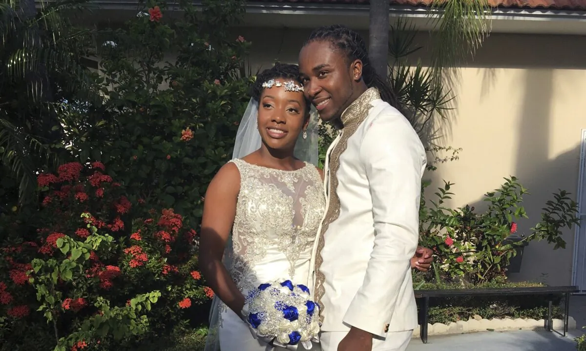 Jean-Dickens Toussaint and his wife Abigail Michael Toussaint pose for a photo at their wedding in Pompano Beach, Fla., on Nov. 9, 2018. (Nikese Toussaint via AP)