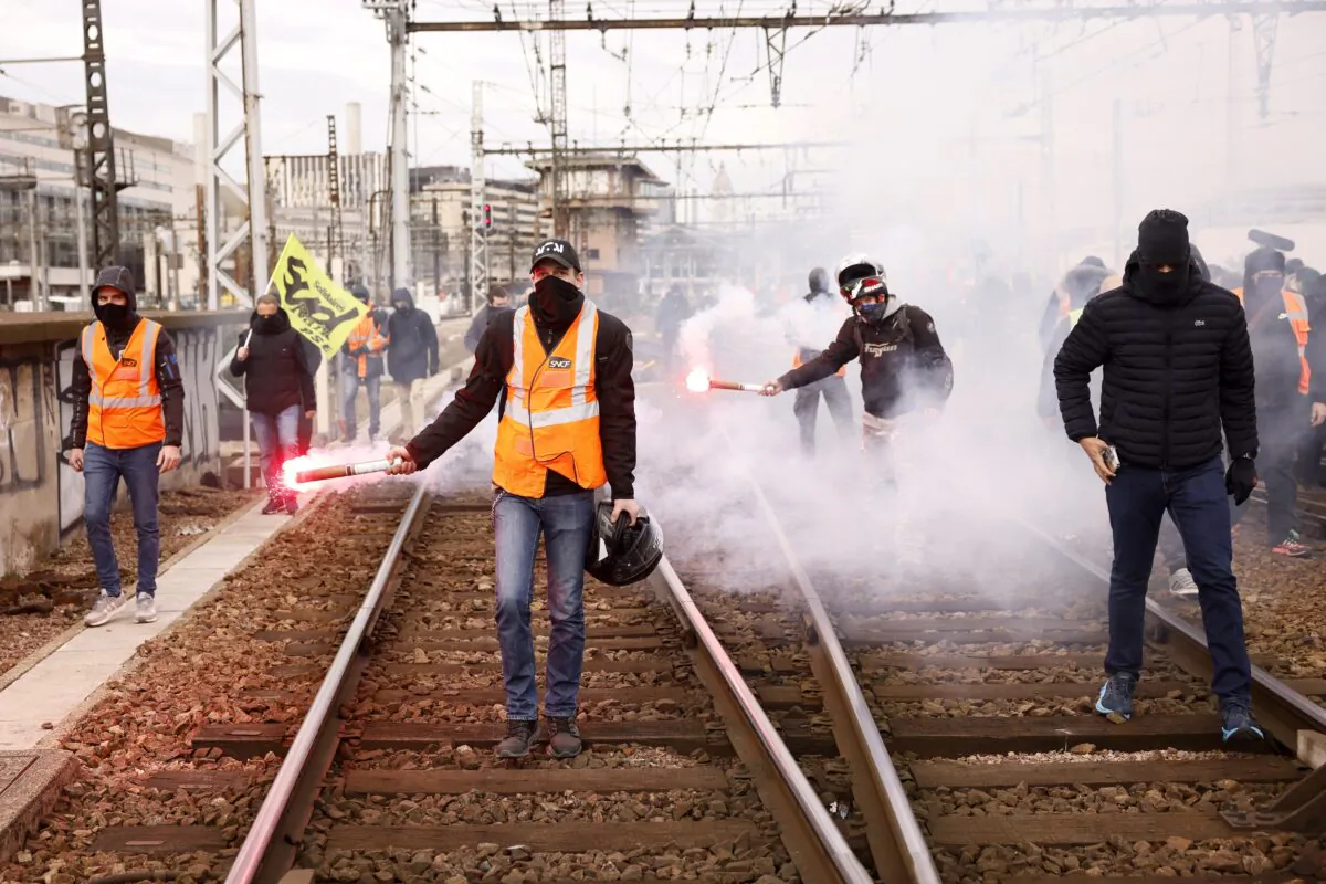 Railway workers demonstrate on the tracks at the Gare de Lyon train station in Paris on March 28, 2023. (Thomas Padilla/AP Photo)