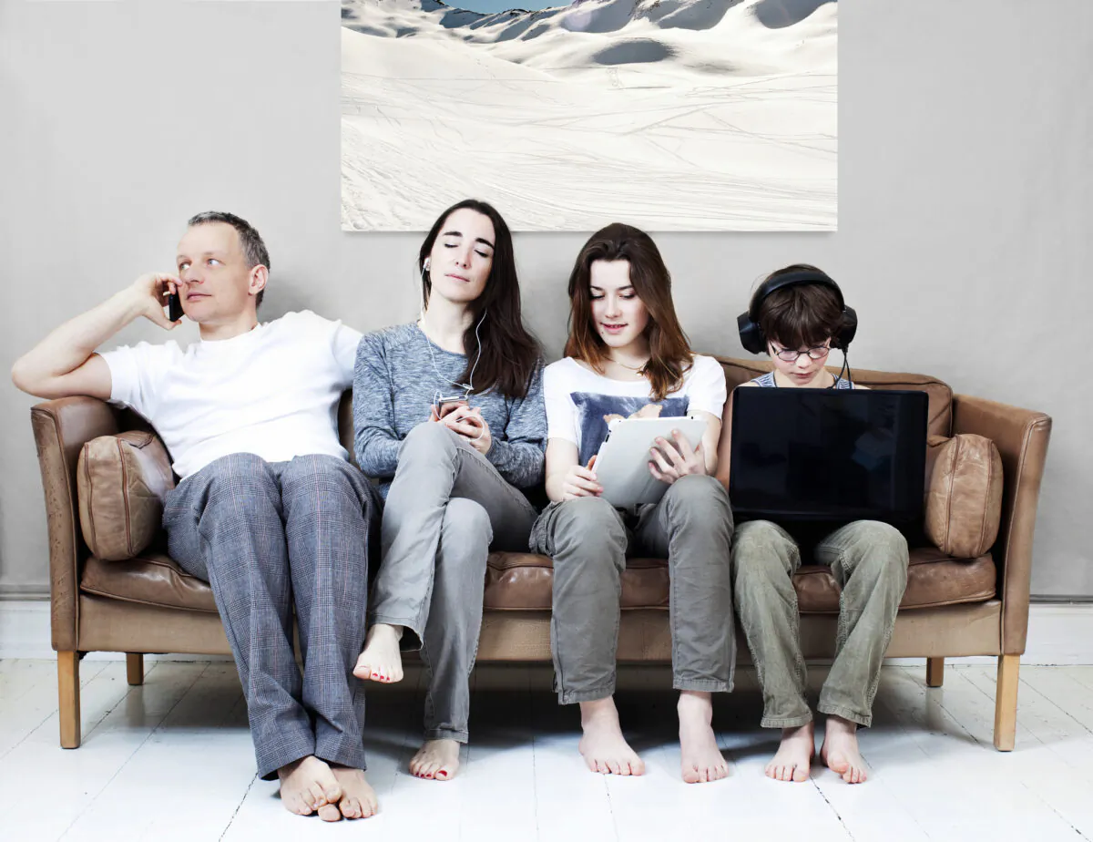 Too much screen time is not only detrimental for children, but also for the parent-child relationship if the parents are paying more attention to their devices than to their kids. ( Muriel de Seze/Getty Images)