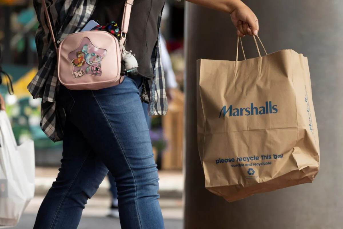 A shopper carries a Marshalls bag in Boston on Oct. 14, 2022. (Michael Dwyer/AP Photo)