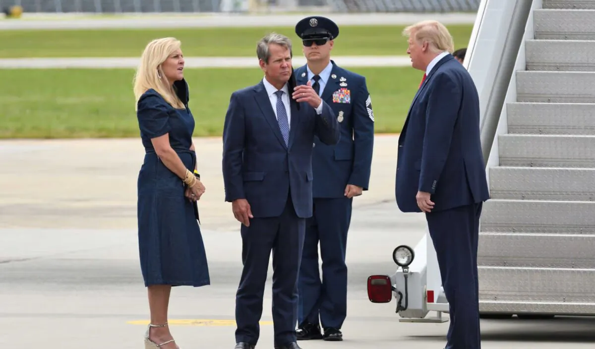 President Donald Trump greets Georgia Governor Brian Kemp and Georgia First Lady Marty Kemp upon exiting Air Force One at Dobbins Air Reserve Base, in Marietta, Ga., on Sept. 25, 2020. (Evan El-Amin/Shutterstock)